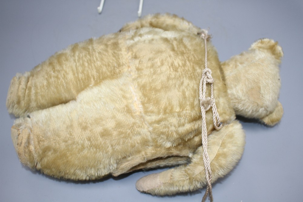 An early 20th century gold plush teddy bear hand warmer, with boot button eyes, length 40cm